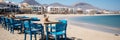 Blue cafe chairs on the sandy mediterranean beach, perfect for a holiday Royalty Free Stock Photo