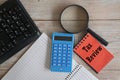 blue calculator and note pad on the table. Taxation concept.