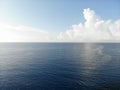 Blue calm sea ocean water with white clouds Royalty Free Stock Photo