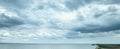 Blue calm sea and sky with clouds. Dramatic pre-storm sky with clouds and gaps Royalty Free Stock Photo