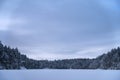 Blue calm winter landscape of a frozen lake in Repovesi National Park, Finland Royalty Free Stock Photo