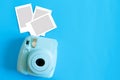 Blue camera with blank picture frames on colourful background. Fashion Film Camera. Nostalgia photography. Top view. Minimal and m