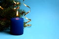 Blue candle lit on holiday christmas background Royalty Free Stock Photo