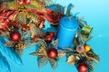 Candle and Christmas decorations on blue background Royalty Free Stock Photo