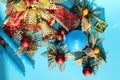 Candle and Christmas decorations on blue background Royalty Free Stock Photo