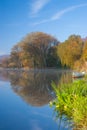 Blue canoe on the river in the mist Royalty Free Stock Photo