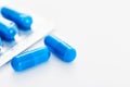 Blue capsule pills white background Copy space Royalty Free Stock Photo