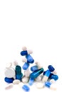 Blue capsules and hidden white in close-up on a cropped white background.