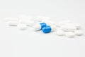 Blue capsules and white antibiotic pills.