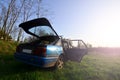 A blue car on a background of a rustic landscape with a wild cane field and a small lake. The family came to rest on the nature n Royalty Free Stock Photo