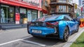 Blue car BMW i8 rear view, stands by the glass wind of a shop in downtown Seoul