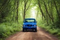 Blue Car on Dirt Road Between Green Leaf Trees generated by Ai