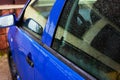 Blue car door handle with rain drops Royalty Free Stock Photo