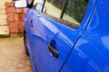 Blue car door handle with rain drops Royalty Free Stock Photo