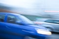 Blue car driving fast on country road Royalty Free Stock Photo