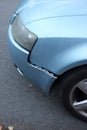 Blue car with a loose bumper, damaged car