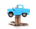 Blue car model jacked by a stack of dollar coins on white background