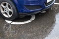 A blue car parked on a sign. place for the disabled. it's raining. autumn. shamefully Royalty Free Stock Photo