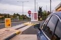 Blue car refuel at the Moreas Motorway-A7 on the background of a sign with prices on May 1, 2022 to ATHENS direction