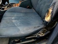 blue car seat with torn upholstery