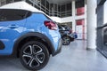 Blue car standing in a row with new cars for rental in car showroom interior Royalty Free Stock Photo