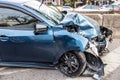 Blue car suffered an accident in front of a car damaged on a road in Bangkok