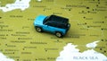 Blue car toy on the Europe map, driving from Ukraine to Poland. War immigration to the west concept. Royalty Free Stock Photo