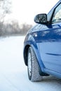 Blue Car with Winter Tires on the Snowy Road. Drive Safe. Royalty Free Stock Photo