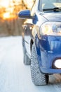 Blue Car with Winter Tires on the Snowy Road. Drive Safe. Royalty Free Stock Photo