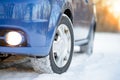 Blue Car with Winter Tires on the Snowy Road. Drive Safe. Royalty Free Stock Photo