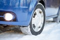 Blue Car with Winter Tires on the Snowy Road. Drive Safe. Royalty Free Stock Photo