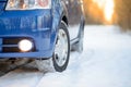 Blue Car with Winter Tires on the Snowy Road. Drive Safe. Royalty Free Stock Photo