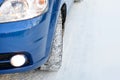 Blue Car with Winter Tires on the Snowy Road. Drive Safe. Space for Text. Royalty Free Stock Photo