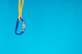 Blue carabiner and a climbing rope, Equipment for belaying in climbing and mountaineering