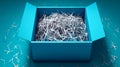 A blue cardboard gift box, open and filled with decorative shredded paper, sits on a white background in a flat lay with Royalty Free Stock Photo