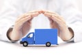 Blue cargo delivery truck protected by hands