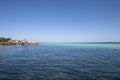 Caribbean sea with crystal clear waters and clear sky. a bungalow with a pier in the middle of the lagoon in a coral