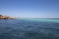 Caribbean sea with crystal clear waters and clear sky. a bungalow with a pier in the middle of the lagoon in a coral Royalty Free Stock Photo