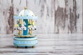 Blue Carousel Music Box on White Wooden Background