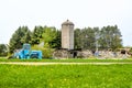 Blue Case Tractor in Front of Destoyed Barn