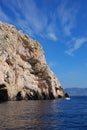 Blue cave on the island of Bisevo in the Adriatic Sea. A white boat sails past the grotto. Croatia Royalty Free Stock Photo