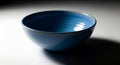 Blue Ceramic Bowl with Glossy Finish on White Surface in Soft Lighting Royalty Free Stock Photo