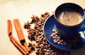 Blue ceramic cup with black coffee drink and coffee beans, cinnamon and star anise spices Royalty Free Stock Photo