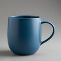 A blue ceramic mug with a smooth, matte finish. The mug has a rounded body and a Royalty Free Stock Photo