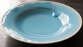 Blue ceramic plate featuring a unique wavy textured design along the rim Royalty Free Stock Photo