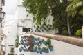 Blue ceramic pots with bright pattern flowers on a white wall. White street of Marbella.