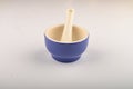 Blue ceramic spice mortar with pestle on white background. Close up