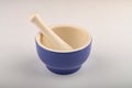 Blue ceramic spice mortar with pestle on white background. Close up