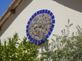 Blue ceramic tile circle on wall with granite stone center