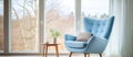 A blue chair by a window in a living room, surrounded by furniture and plants Royalty Free Stock Photo